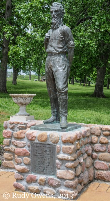 A statue of the abolitionist and revolutionary John Brown stands guard at a park with his namesake in Osawatomie, Kan.