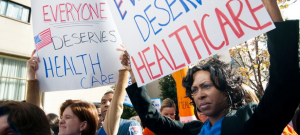 Photo courtesy of Harvard, showing people protesting for health care access. But most of us want health pricing information too, and are prevented from getting that by providers and insurance companies.